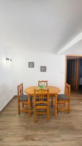 a wooden table and chairs in a room at Atico el Wiro in Puerto +7 photos