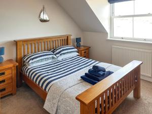 a bedroom with a bed with blue towels on it at Top O' The Brewery in Scarborough