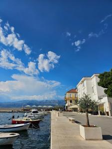 a group of boats are docked next to the water at Apartmani Banić Apartman 5 in Postira