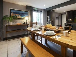 a dining room with a table and a kitchen at St Hildas Rest in Hinderwell