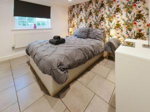 a bedroom with a bed with a teddy bear on it at St Hildas Rest in Hinderwell +9 photos