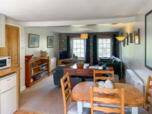 a kitchen and living room with a table and a couch at Cauldron Falls in West Burton +8 photos
