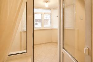a glass shower door in a room with a window at Apartment Deluxe on Moscow Avenue in Chişinău +11 photos