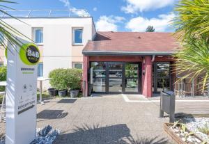 a building with a sign in front of it at B&B HOTEL Bordeaux Mérignac Cadera Aéroport in Mérignac