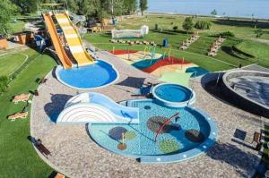 a playground with a water park with a water slide at Villa Sole Apartman Balatonboglár in Balatonboglár