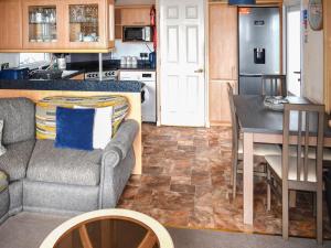 a kitchen and living room with a couch and a table at Apple Grove 24 in Exmouth