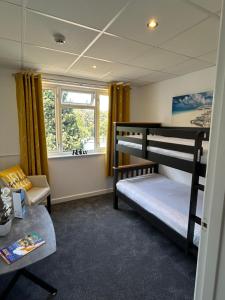 a room with two bunk beds and a window at Westhill Country Hotel in Saint Helier Jersey +90 photos