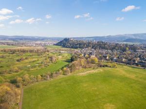 an aerial view of a green field with a city at Applepips in Stirling +19 photos