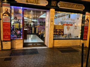 a store front with its doors open on a street at Hotel Saint Francois Xavier in Lourdes