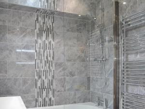 a bathroom with a shower with a tub and a sink at White Towers - Hw7625 in Llandwrog +8 photos