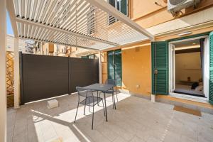 a patio with a table and chairs on a building at Hidden Pyramid Suites in Rome