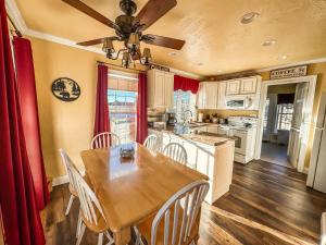 a kitchen with a wooden table and a dining room at New: Charming and Cozy Great Value in Swanton