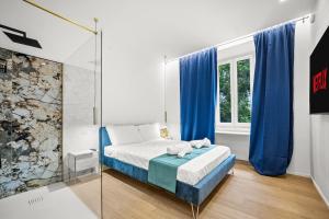 a bedroom with a bed with blue curtains and a window at Hidden Pyramid Suites in Rome