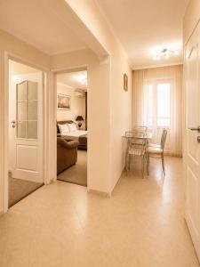 a living room with a table and a bedroom at Apartment Deluxe on Moscow Avenue in Chişinău