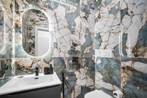 a bathroom with a sink and a mirror at Hidden Pyramid Suites in Rome