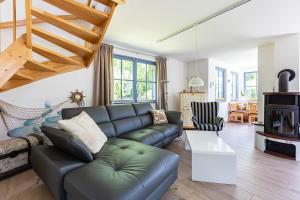 a living room with a couch and a table at Strandmuschel in Born