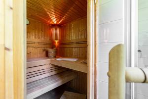 a sauna with wood paneling and a wooden floor at Strandmuschel in Born +27 photos