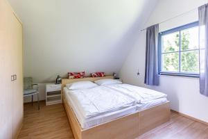 a bedroom with a large bed and a window at Strandmuschel in Born