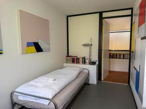 a bedroom with a bed and a painting on the wall at Villa Cavalli in Verscio