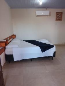 a bedroom with two beds in a room at Pousada laranja in Xangri-lá +5 photos