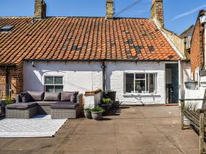 a white house with an orange roof at The Photographer's House in Southwold