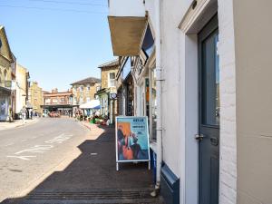 a sign on the side of a building next to a street at The Photographer's House in Southwold