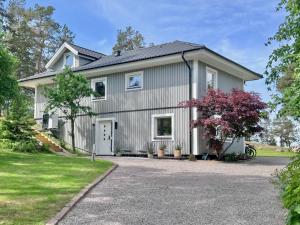 a house with a gravel driveway at Modern Seaside Guesthouse with Archipelago Views in Nacka