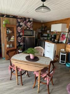 a kitchen with a table and chairs in a kitchen at Le Chalet in Taillet