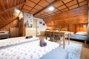a room with two beds and a table in it at Chaloupka u Borovků in Vyskeř