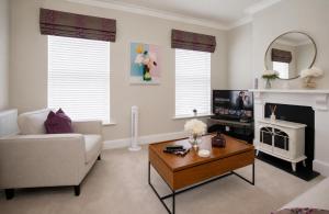 a living room with a couch and a table at Lucy's Lodge- Most Stylish Apartment On Vibrant Bishy Road with Free Parking in York