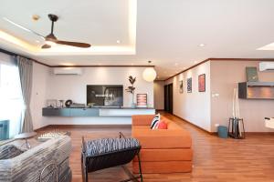a living room with a couch and a table at Capitel Ekkamai Hotel in Sathani Khlong Tan +131 photos