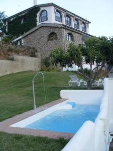 a swimming pool in front of a house at Posada Real Quinta de la Concepción in Hinojosa de Duero