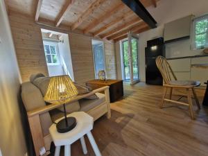 a living room with a couch and a table at In het sprookjesbos in Zonnebeke