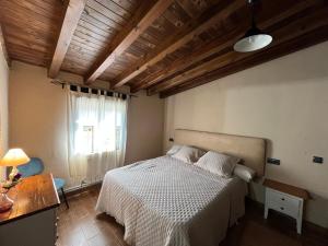 a bedroom with a white bed and a window at Casa Rural Valle del Jerte in Jerte +15 photos