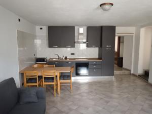 a kitchen with a table and chairs in a room at Nonna Lidie in Aymavilles