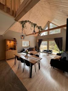 a large living room with a table and a couch at Jūrmalciema Pērle AMBER in Jūrmalciems