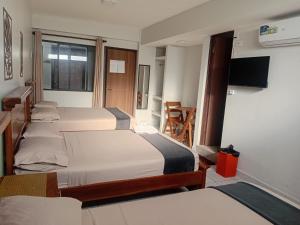 a room with a bunch of beds in it at Hostal Center A in Santa Cruz de la Sierra