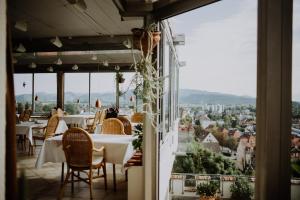 a restaurant with tables and chairs and a view of the city at BoutiqueHotel KAPUZINERGARTEN in Breisach am Rhein