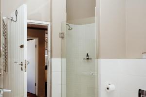 a bathroom with a shower with white walls at Duifie in Paternoster