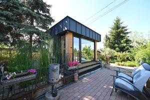 a tiny house on a patio with a fence at Vintage Home Vendégház in Miskolctapolca