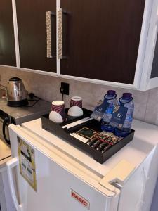 a tray on the top of a white refrigerator at جولدن نيو الدار للشقق المخدومة in Jazan +8 photos