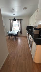 a kitchen with a table and chairs and a dining room at Björklunden in Sollefteå