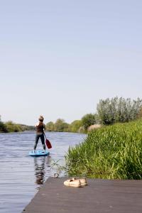a person on a paddle board on a river at Mooirivier in Dalfsen