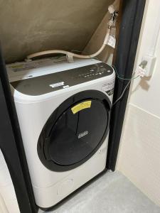 a microwave in a refrigerator with a cord on it at 宿丸一 in Tajimi