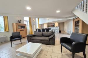 a living room with a couch and chairs at Spacious duplex house in Grosbreuil in Grosbreuil