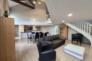 a living room with a couch and a table at Spacious duplex house in Grosbreuil in Grosbreuil