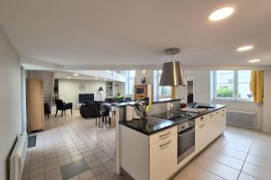 a kitchen and living room with a table and a counter at Spacious duplex house in Grosbreuil in Grosbreuil +19 photos