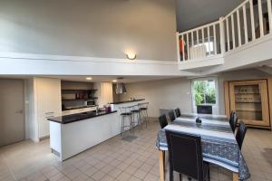 a kitchen and dining room with a table and chairs at Spacious duplex house in Grosbreuil in Grosbreuil