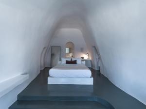 a bedroom with a white bed in an attic at Santonero in Akrotiri +53 photos