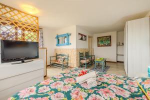 a bedroom with a bed and a flat screen tv at Rai's Room 1 - Nature and Panoramic View in Stazione Olbia